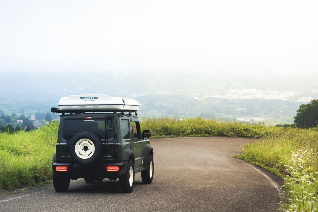 Green Jimny Sierra with Roof Tent on Road
